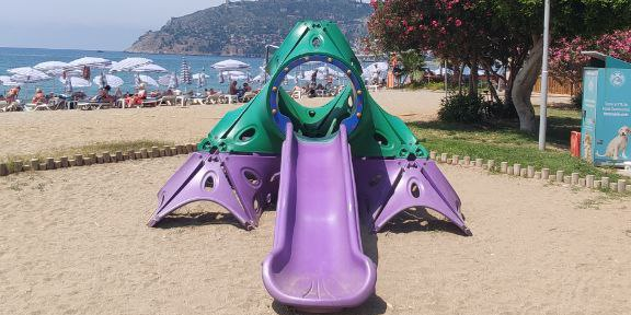 Walking path along the sea with exercise equipment and playgrounds