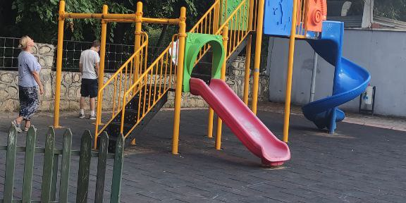 Children's playground with park area, fountain and fair